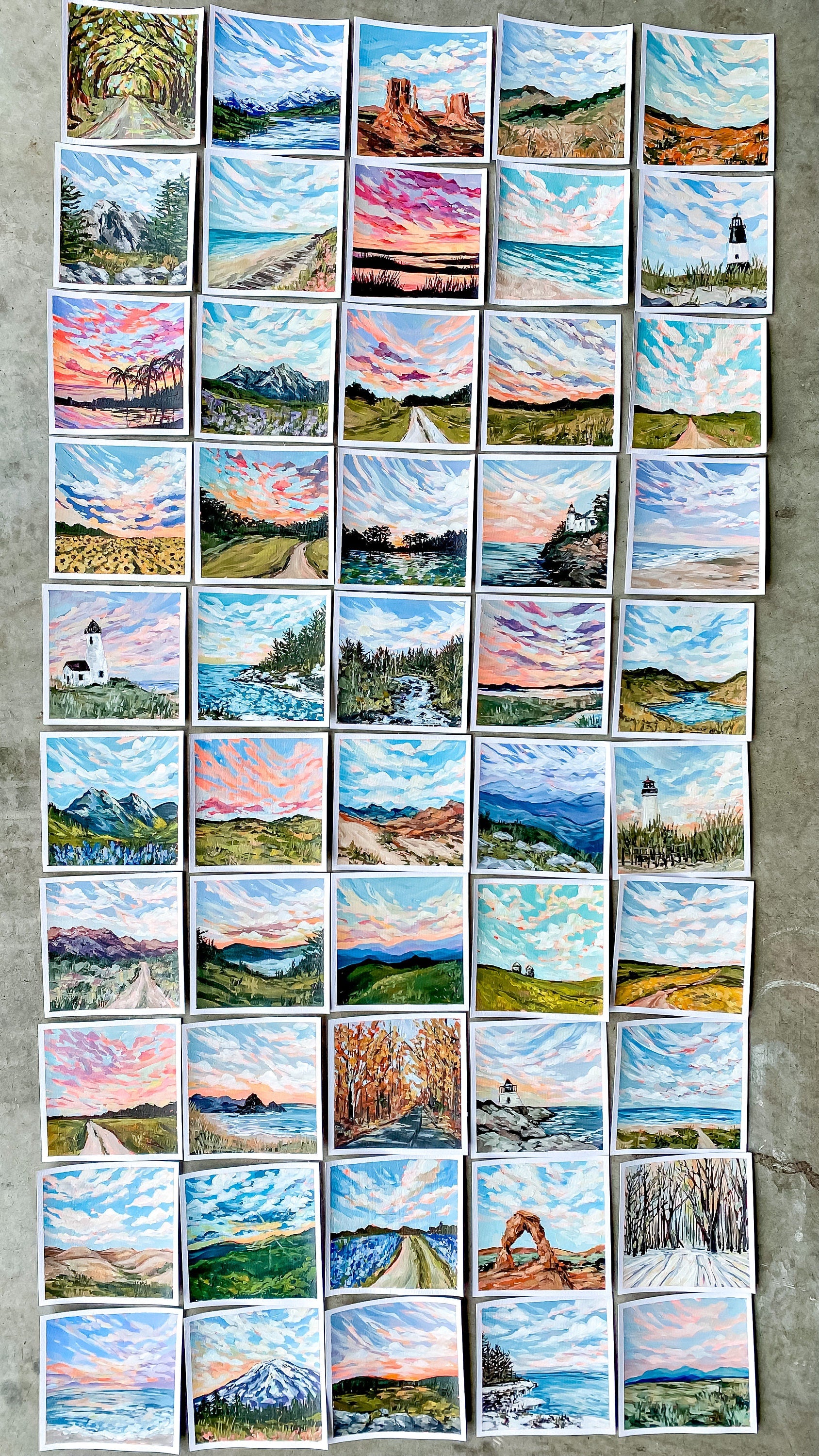 Collection of small landscape paintings arranged in a grid on a textured surface.