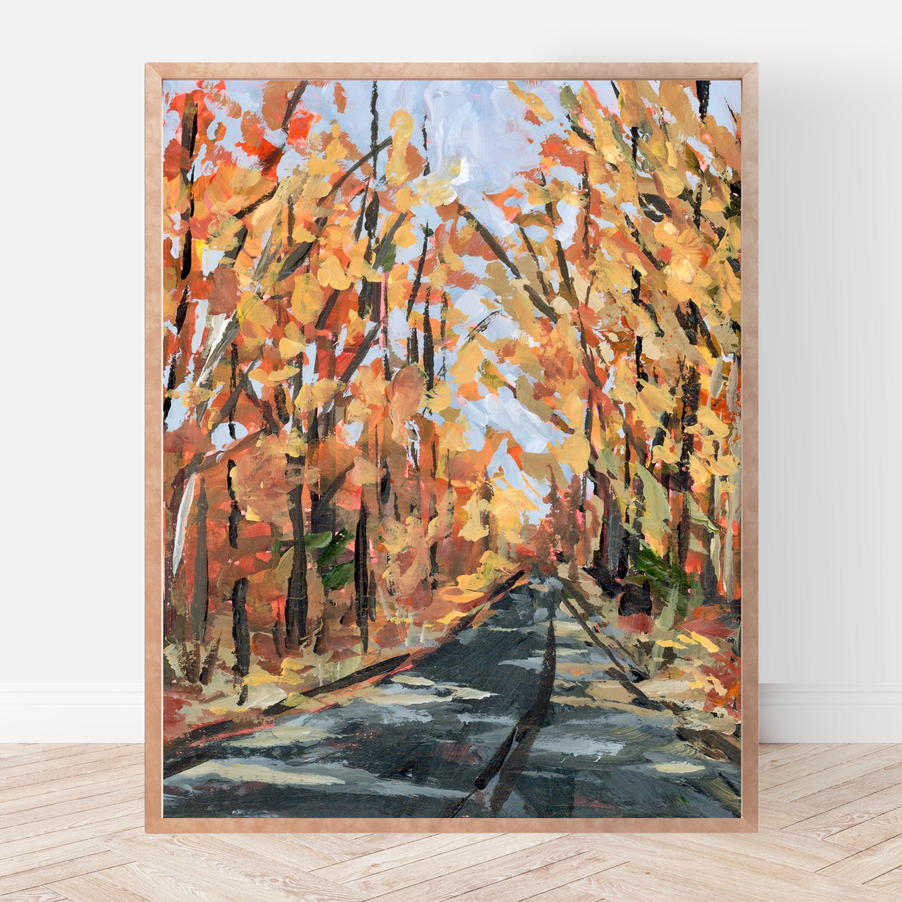 Framed print of a autumnal landscape with trees and a path.