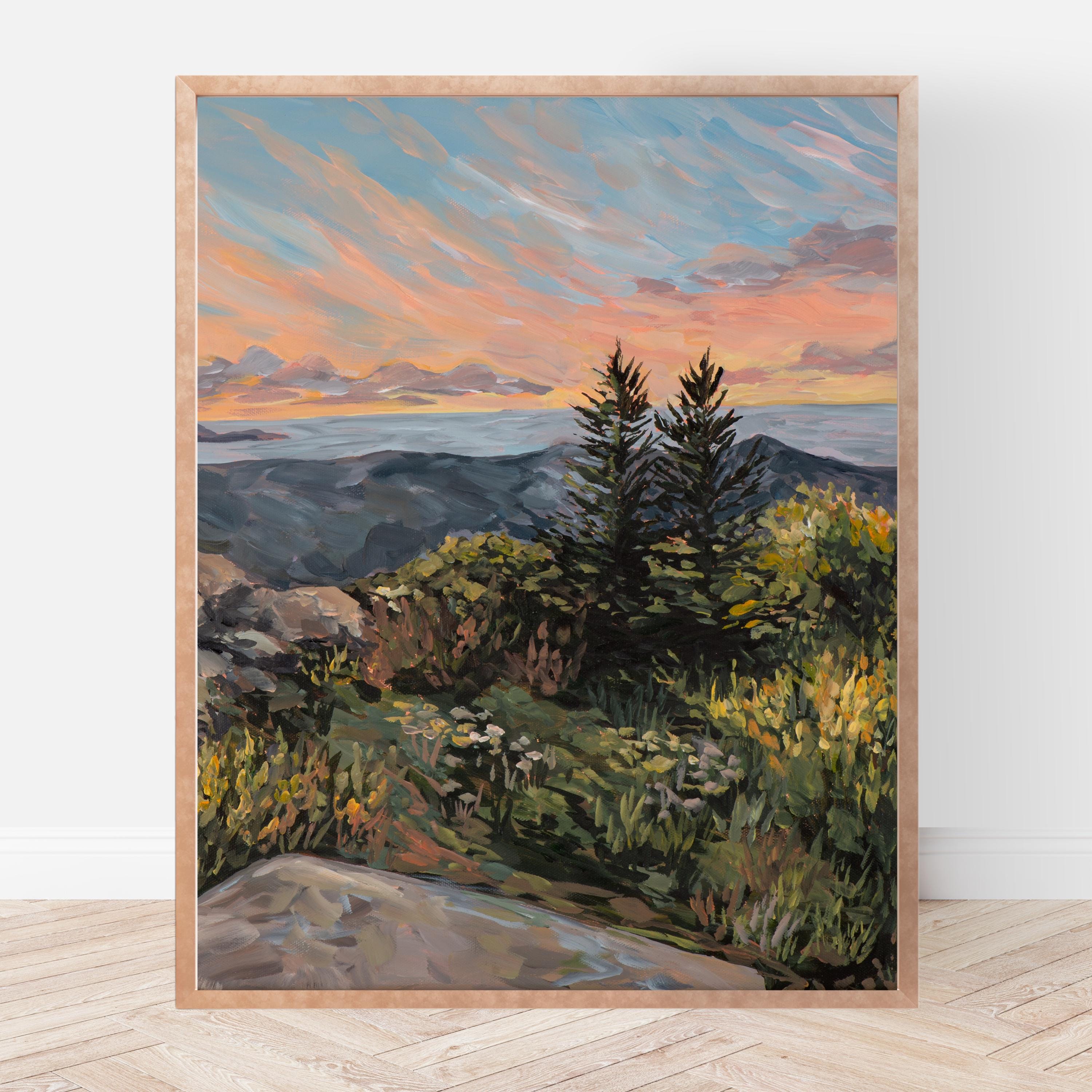 Framed painting of a mountain landscape with a sunset sky.