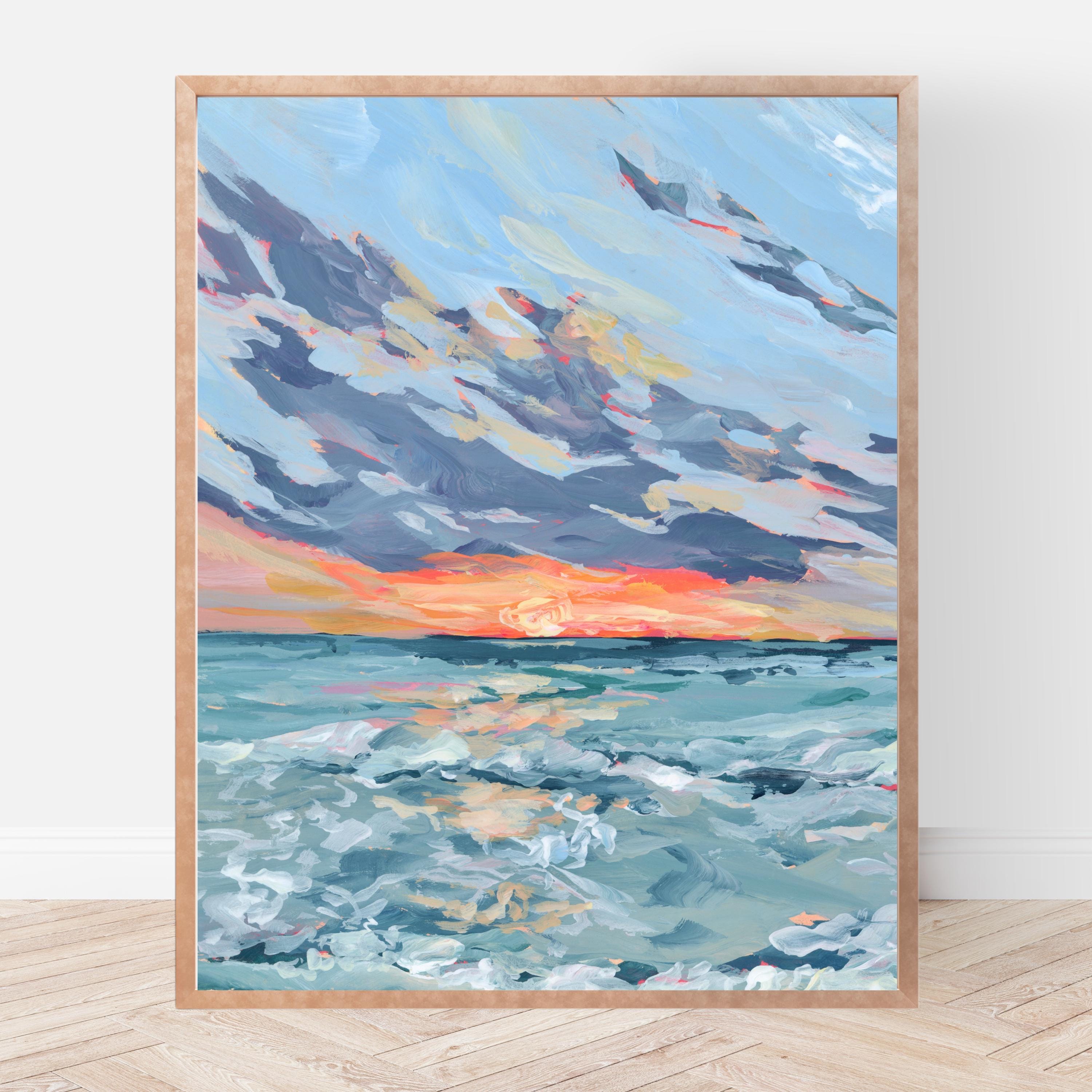Framed painting of a purple and orange sunset over the ocean on a white wall.