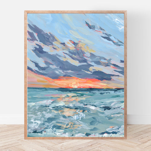 Framed painting of a purple and orange sunset over the ocean on a white wall.