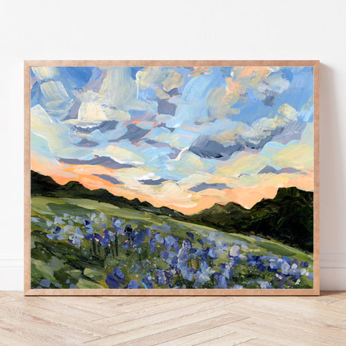 Framed landscape print of a Texas bluebonnet field underneath a blue sky fading into an orange sunset. 