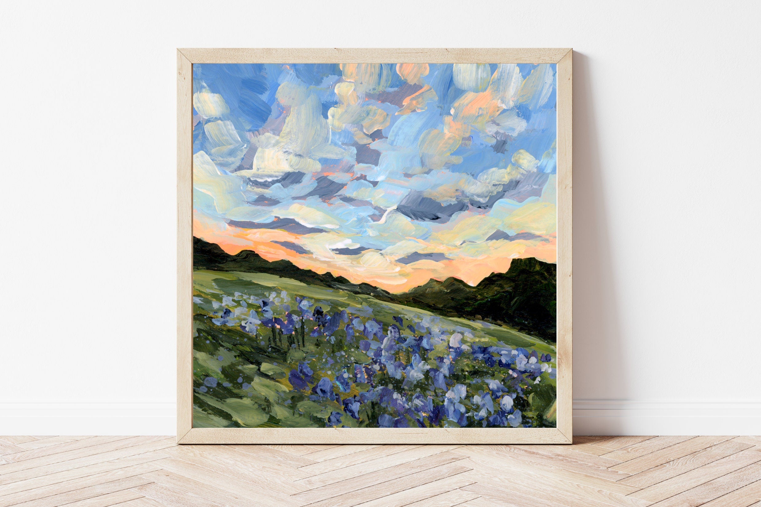 Framed landscape print of a Texas bluebonnet field underneath a blue sky fading into an orange sunset. 