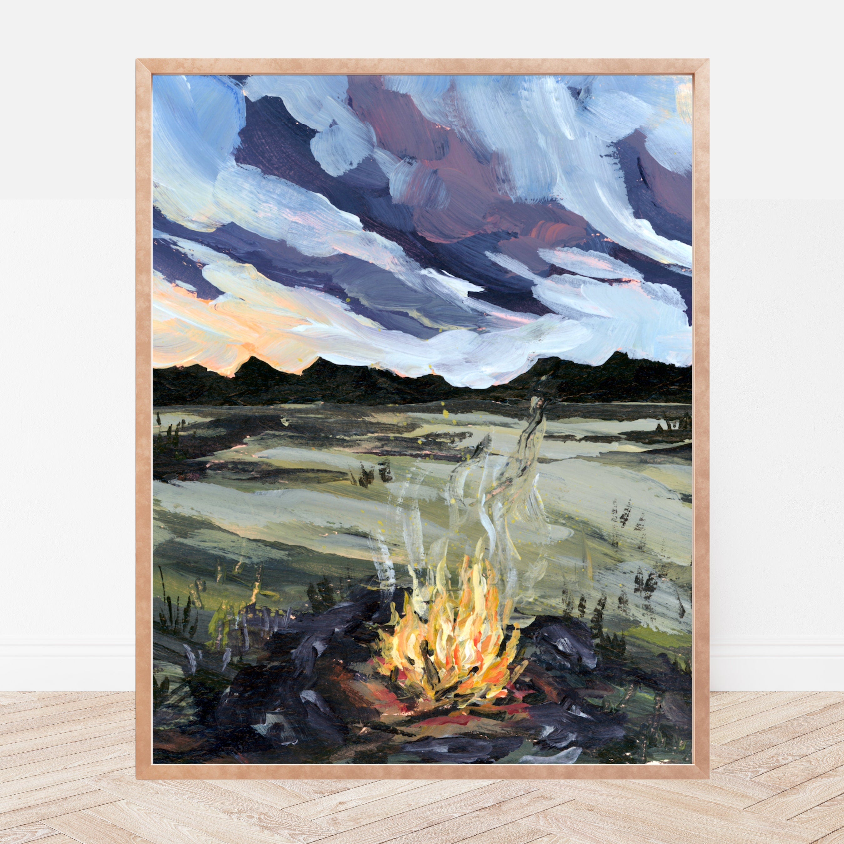 Framed art print of a campfire with a landscape and sky in the background