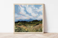 Framed print of a Colorado Springs mountain landscape, against a white wall. 