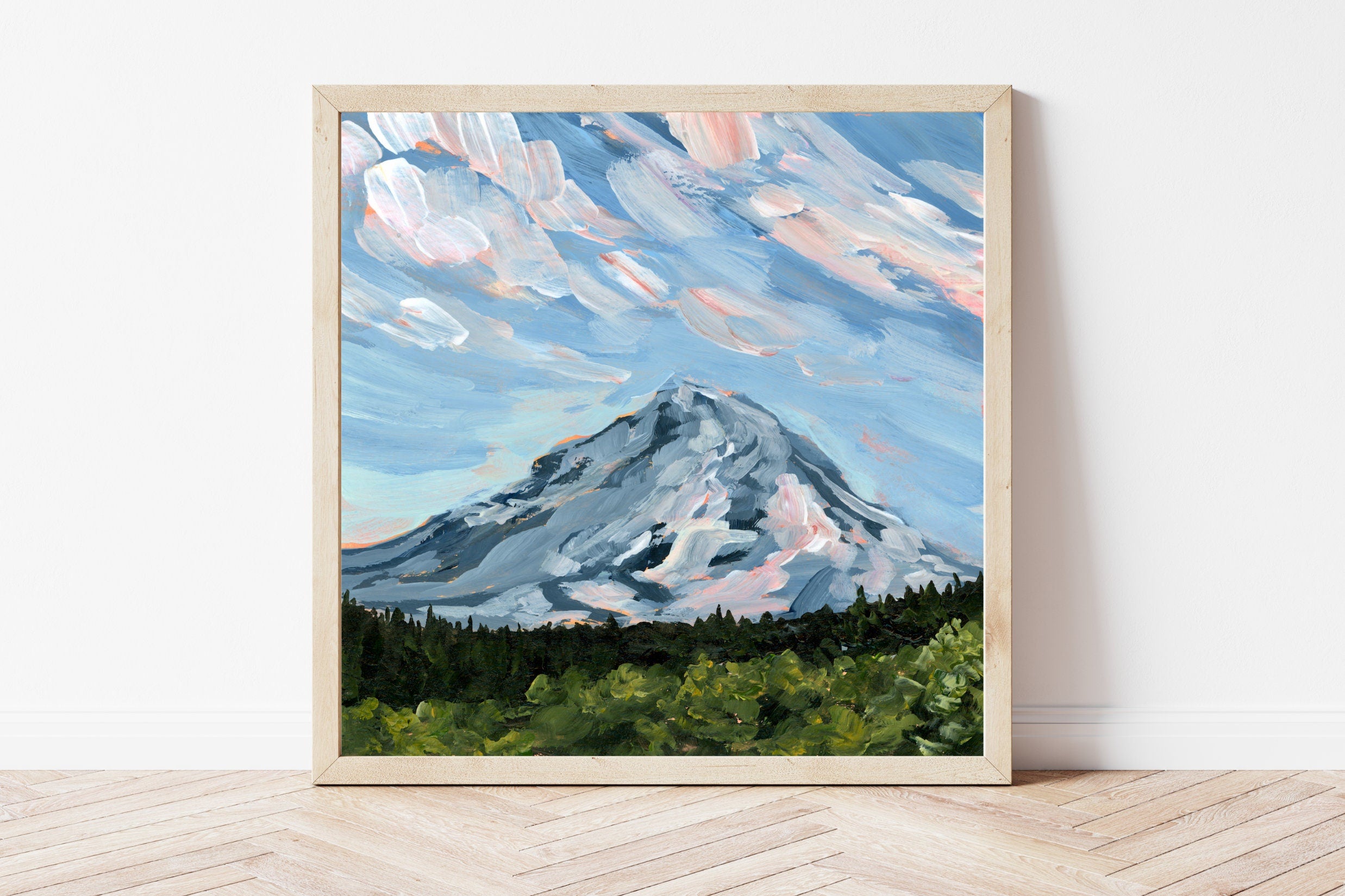 Framed landscape artwork featuring Oregon's Mount Hood underneath a blue sky with bright white clouds. 
