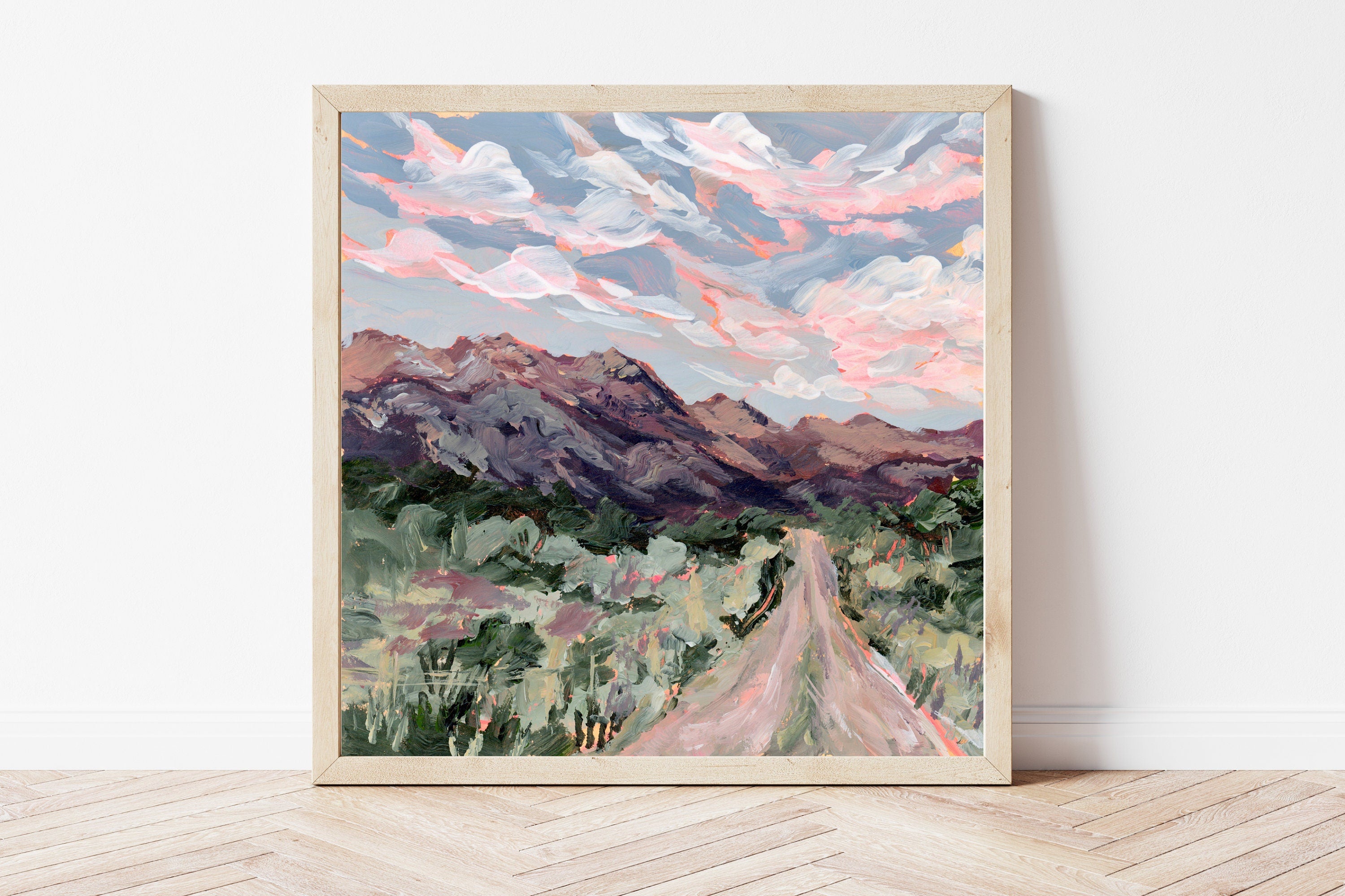 Framed fine art print of a mountain landscape with a road and colorful sky.
