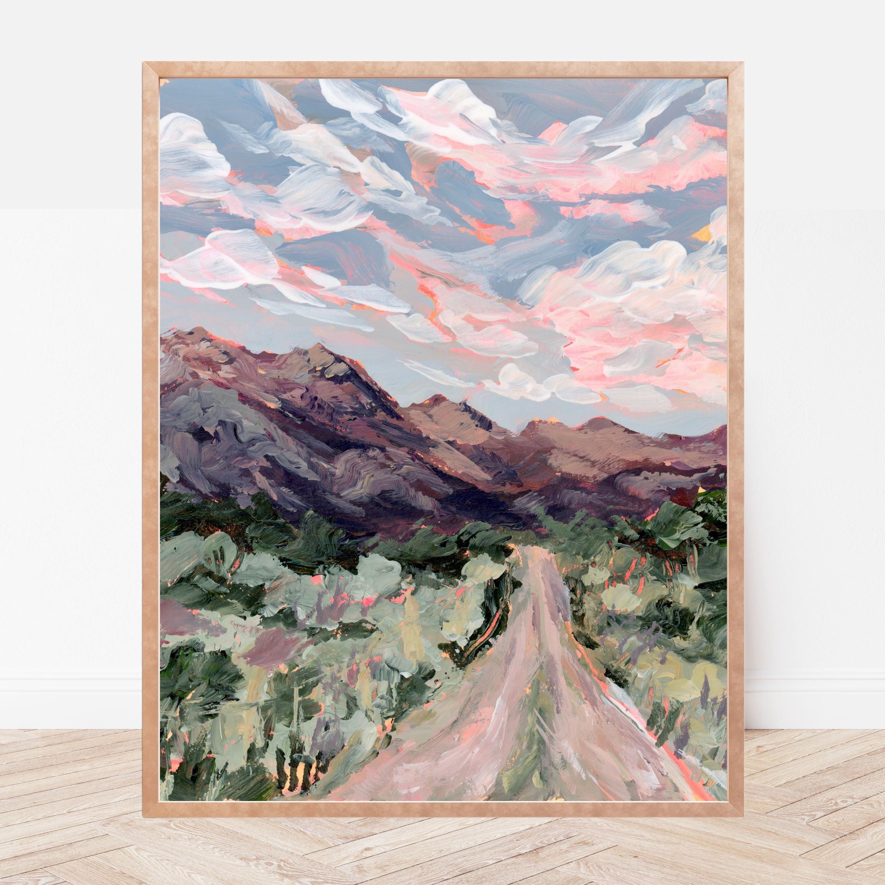 Framed painting of a mountain landscape with a road and colorful sky.