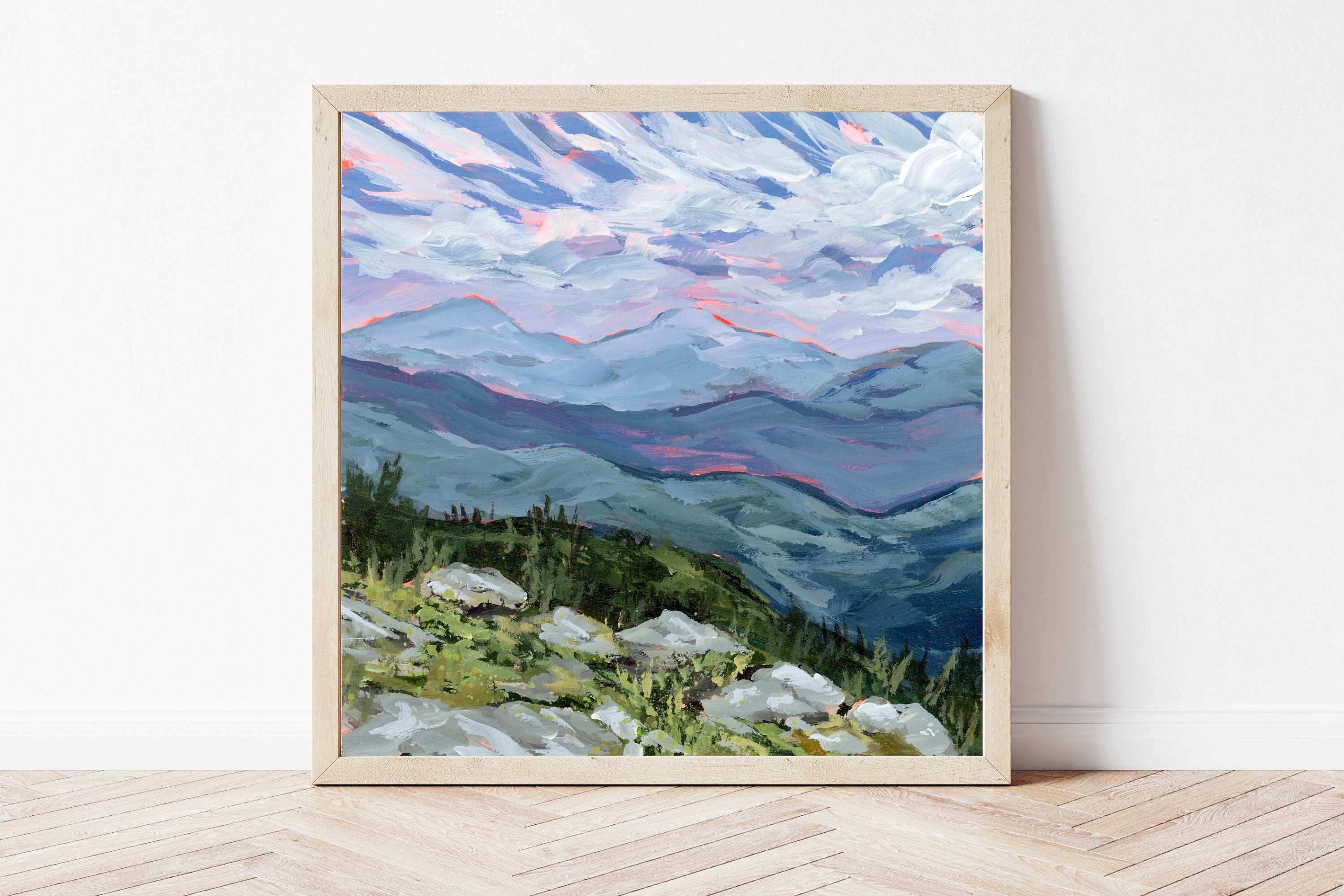 Framed print of a landscape overlooking the White Mountains in New Hampshire underneath a blue sky. 