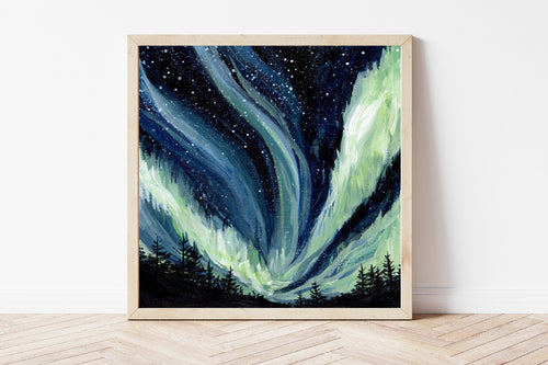 Framed artwork of aurora borealis against the dark night sky in Alaska, with the dark silhouette of pine trees in the foreground. 