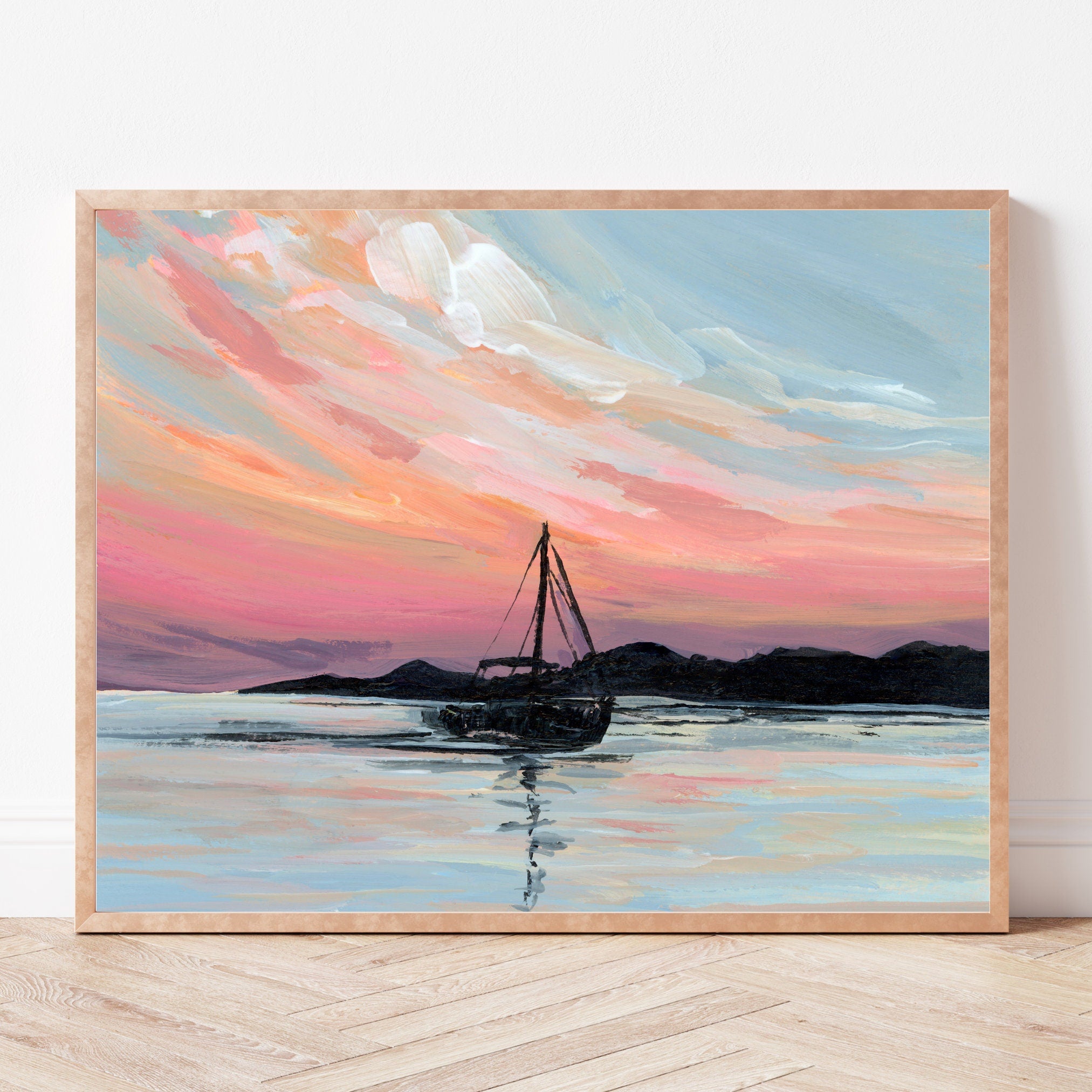 Framed painting of a sailboat on water with a colorful sky.