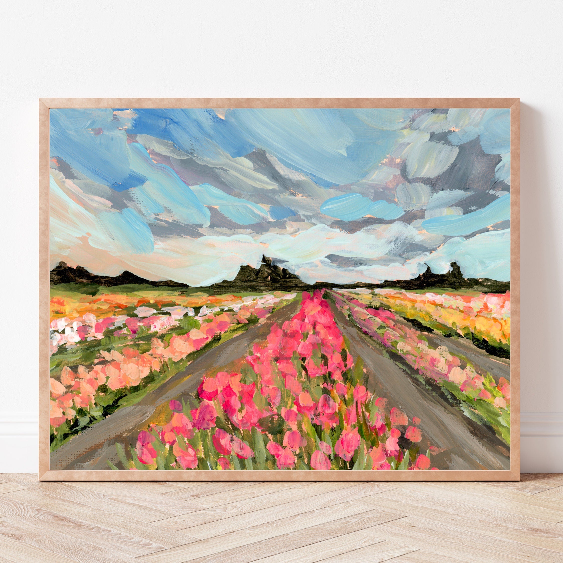 Framed painting of a large field of tulip flowers with a blue sky.