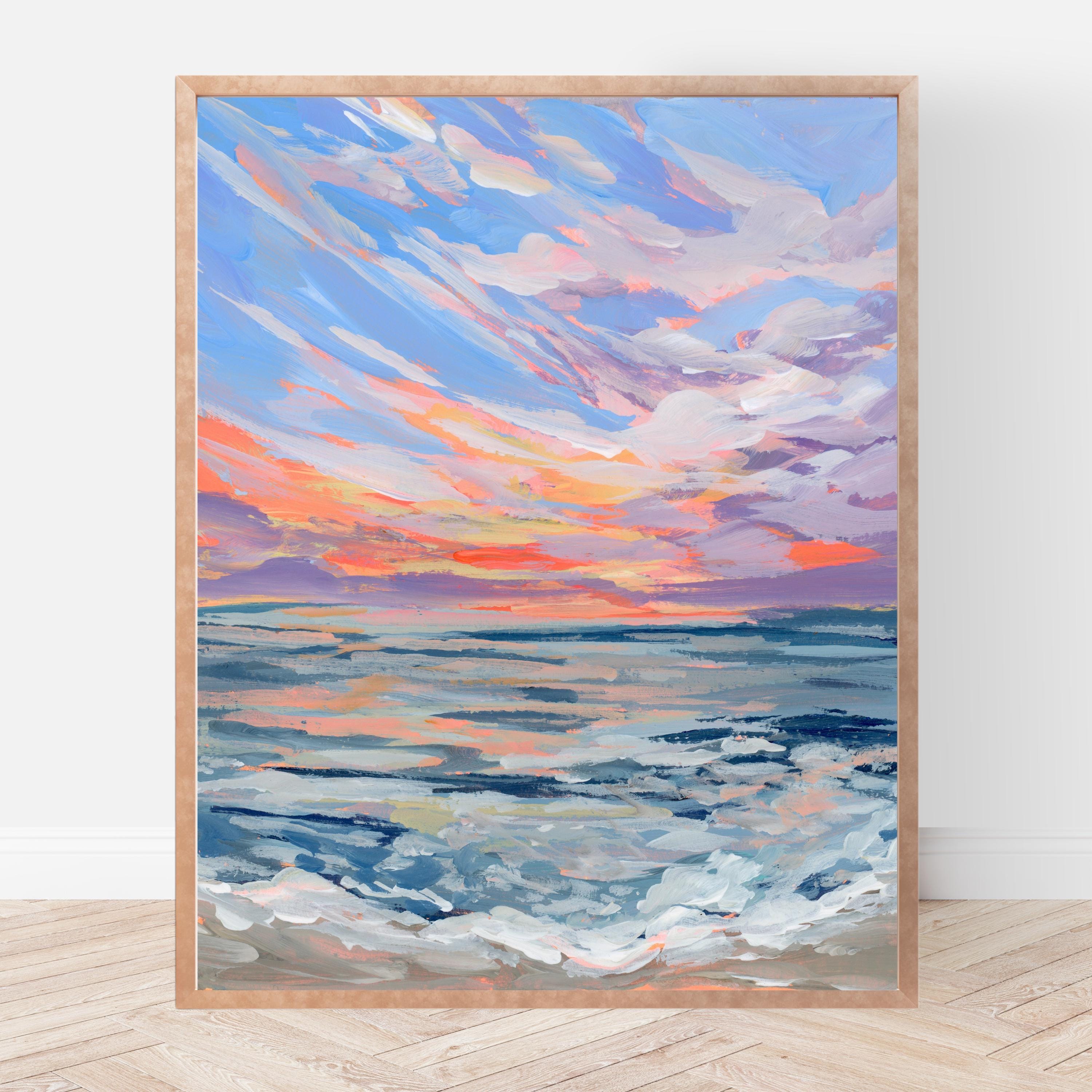 Framed art print of a blue sky fading into an orange and purple sunset over the ocean. 