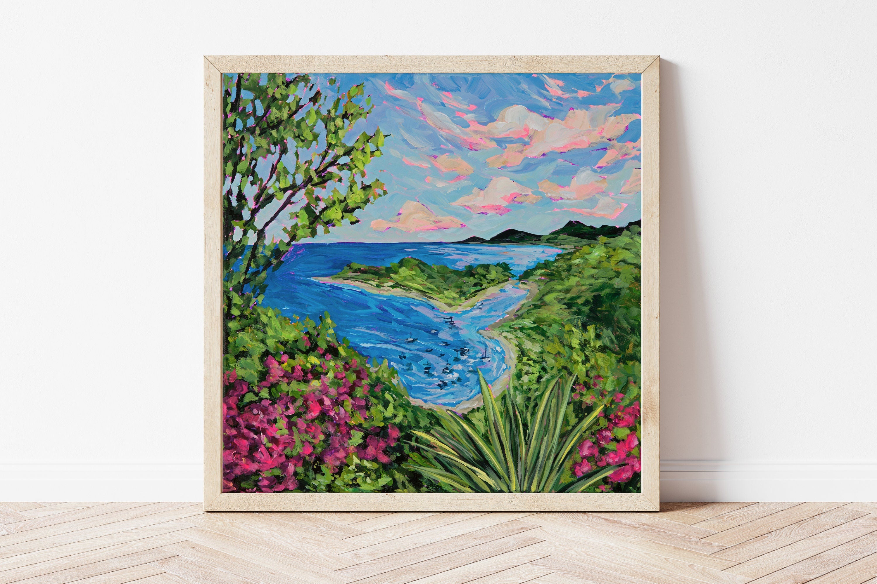 Framed art print featuring pink and green tropical foliage overlooking a bay of sailboats.