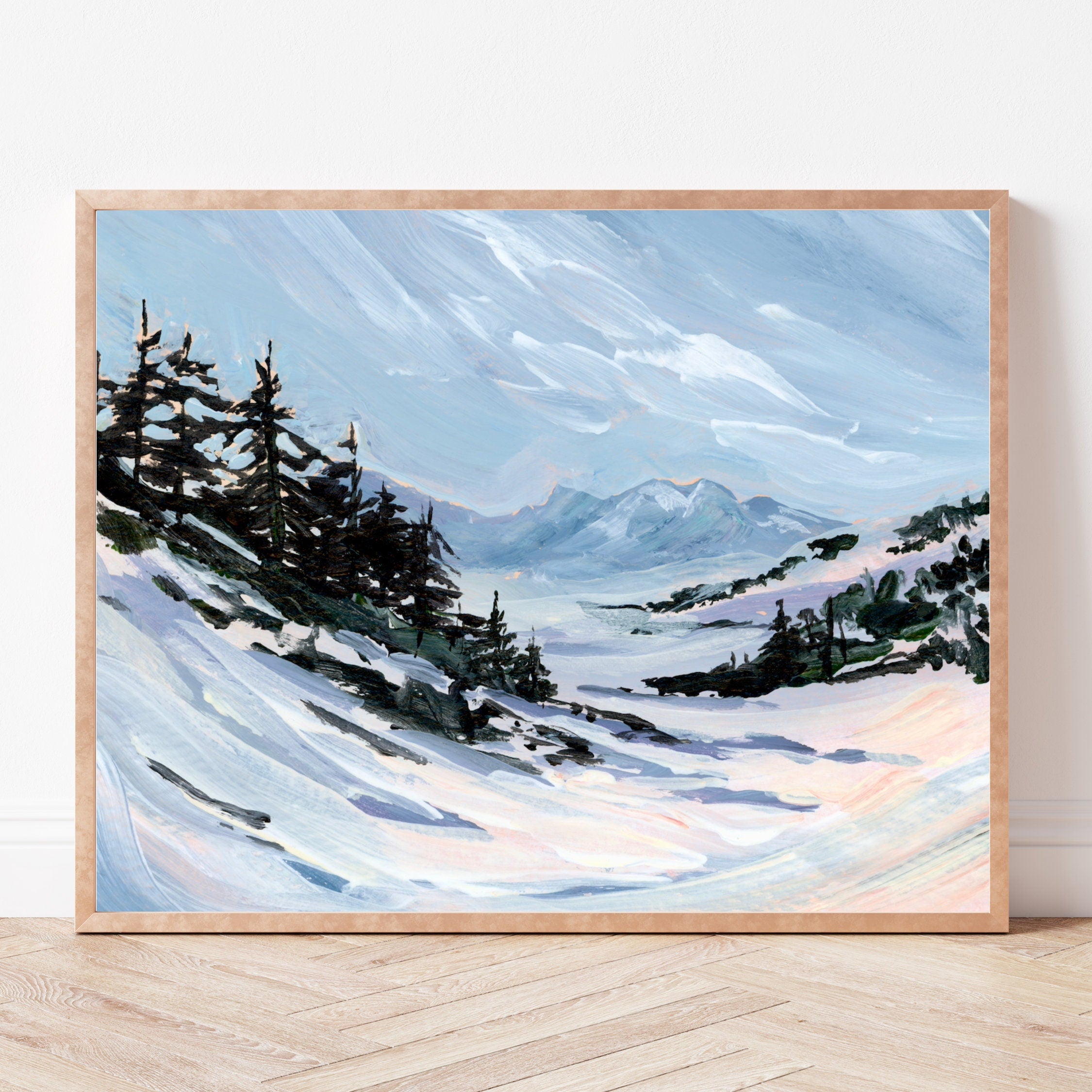 Framed painting of a snowy landscape with trees and mountains.