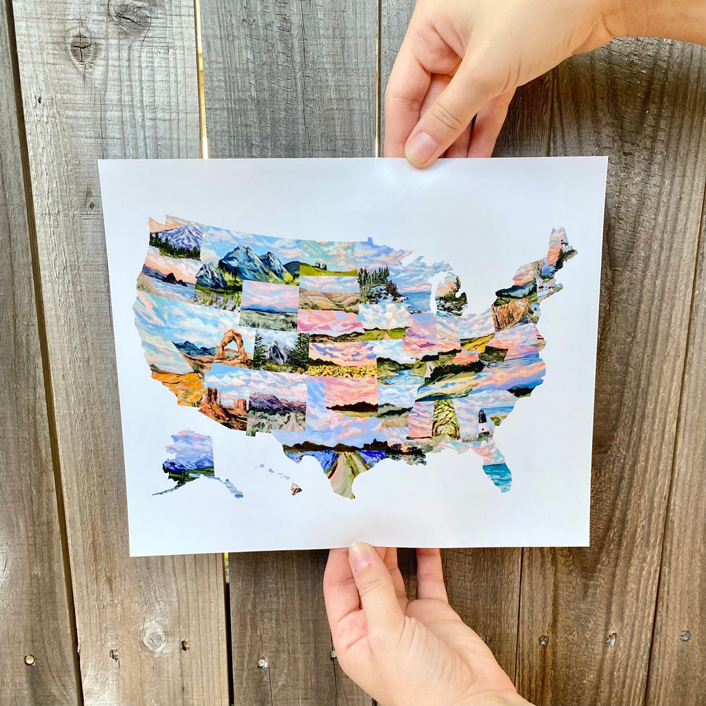 Colorful map of the United States held by a hand on a wooden surface
