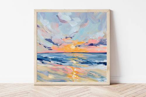 Framed abstract painting of a sunset over water on a white wall.