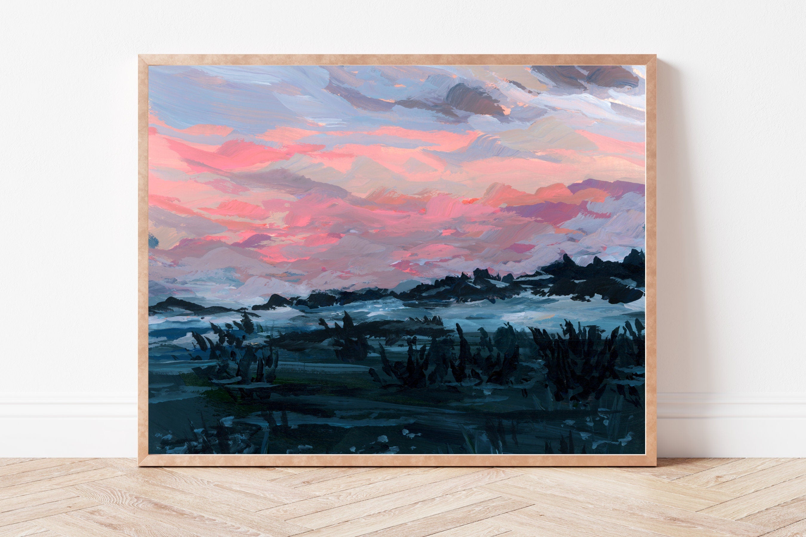 Framed art print of a hazy blue-toned landscape beneath a pink morning sky. 