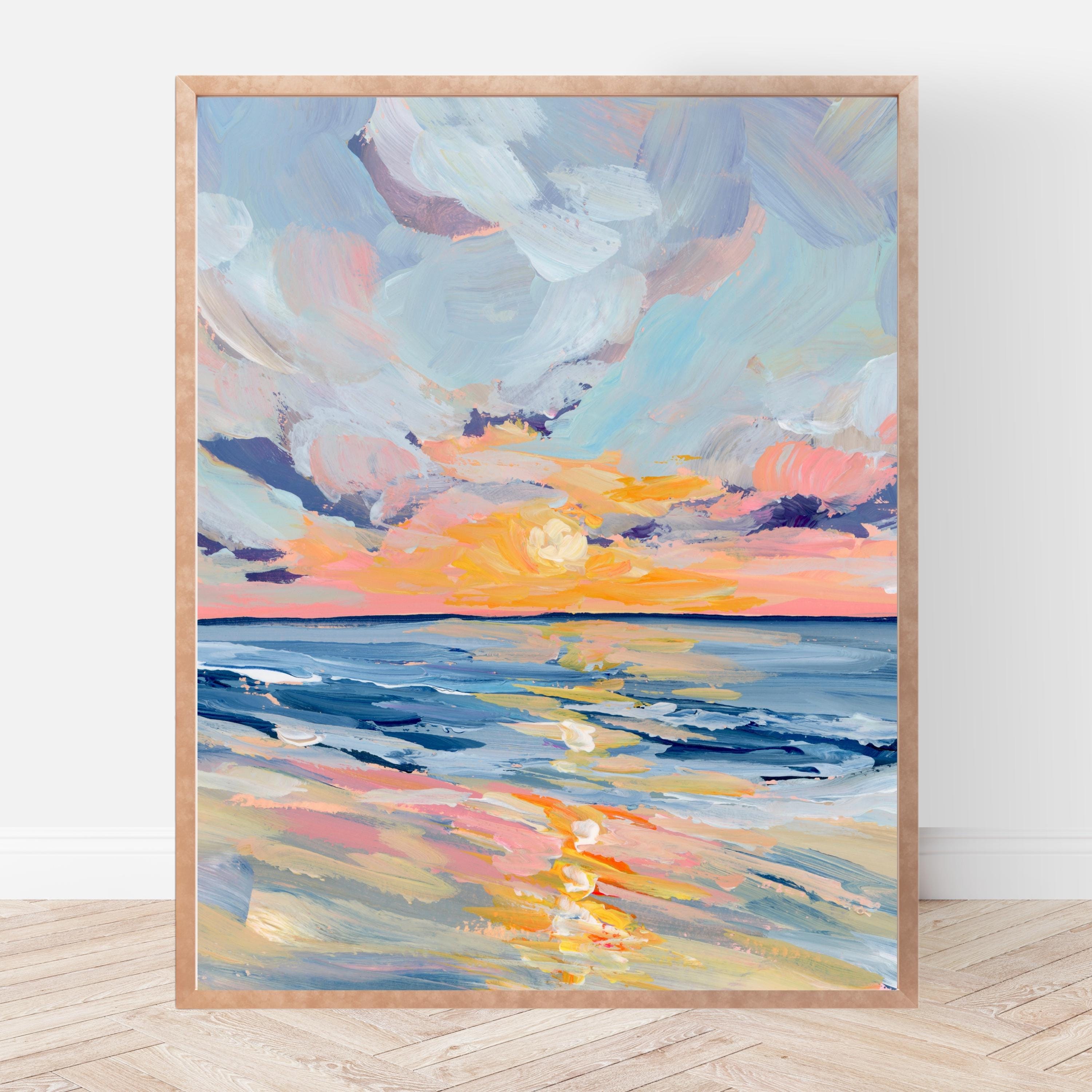 Framed abstract painting of a sunset over water on a white wall.
